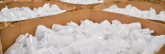 Plastic bottles in boxes.
